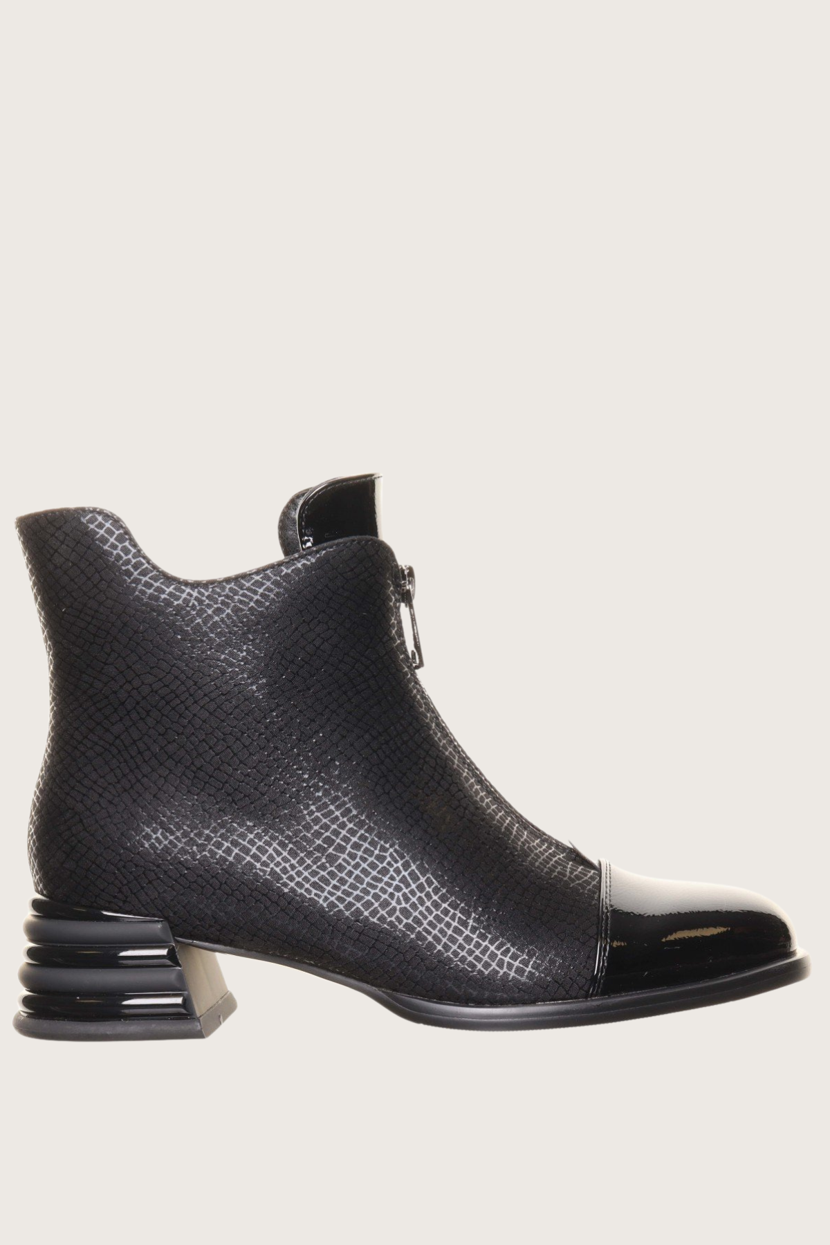 Black ankle boot with a unique sole design on a light gray background