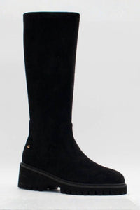 A single black suede knee-high boot with a chunky lug sole, shown from a side profile against a light gray background.